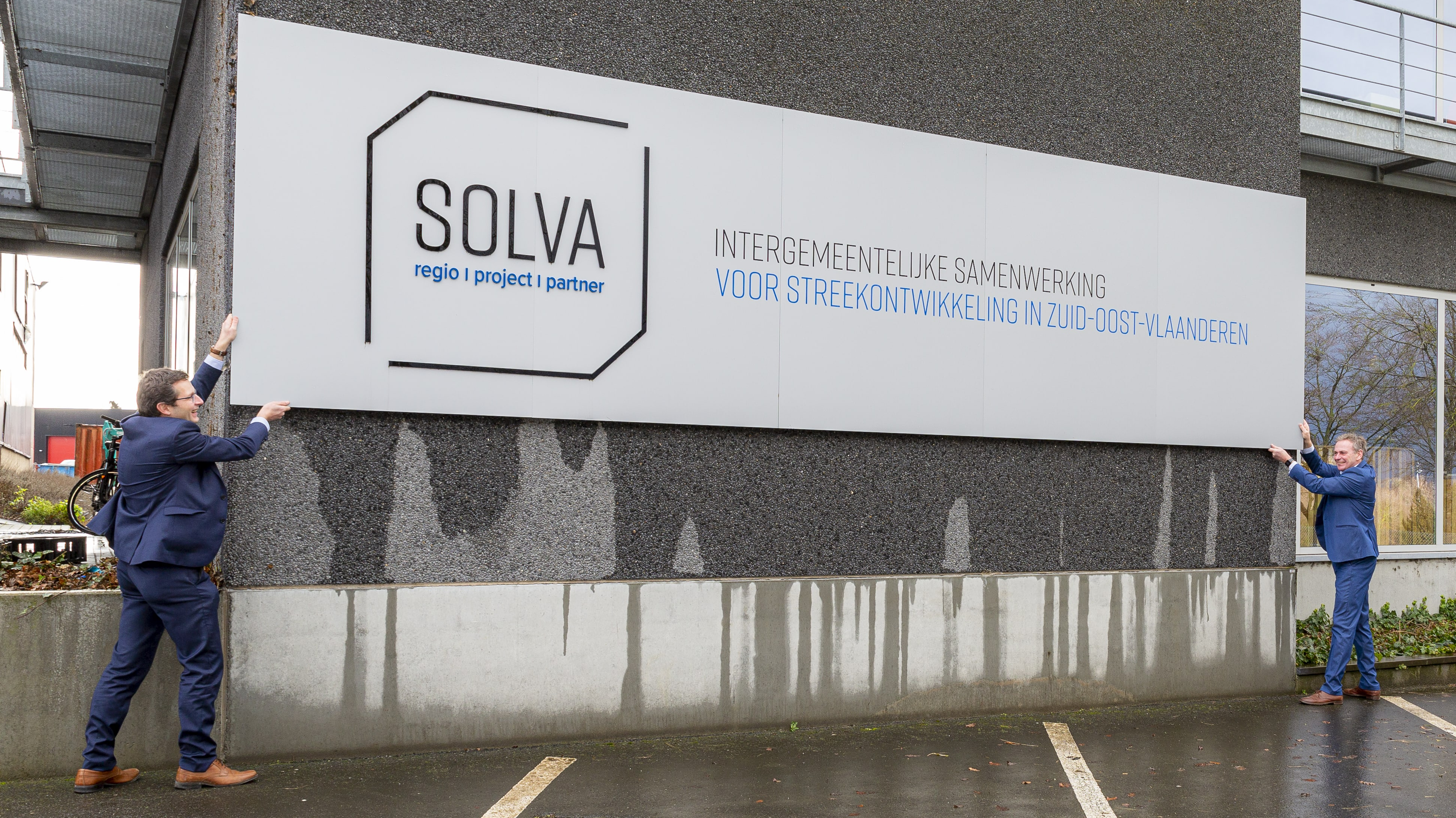 Nieuwe en ex-voorzitter SOLVA houden naambord SOLVA vast